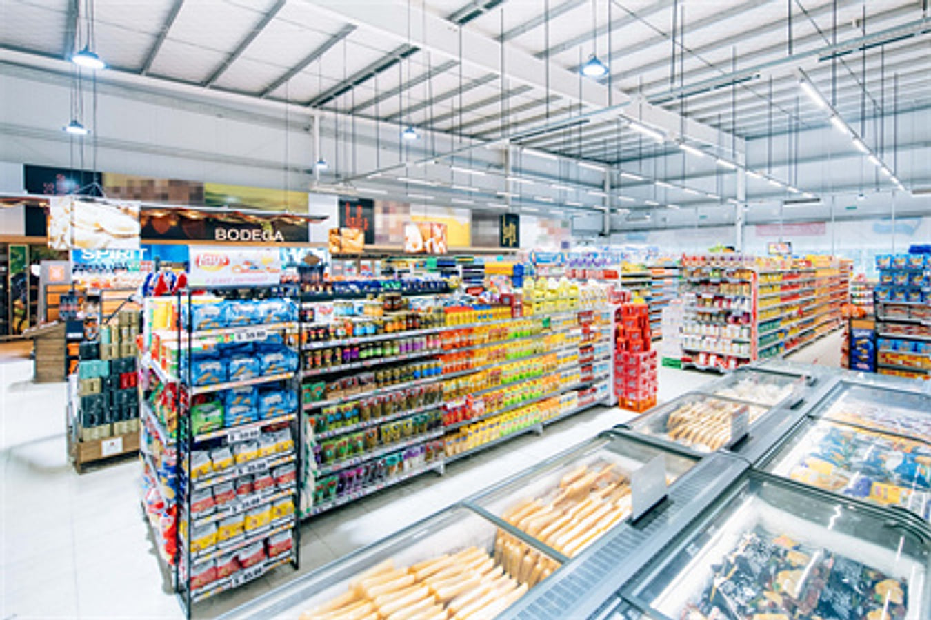Modern supermarket interior with stocked display shelves